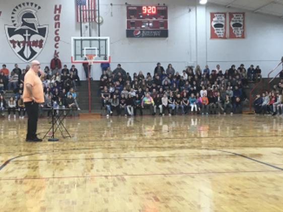 Andrew Dewey, a recovered substance user, speaks to a crowd of students from the local schools about his journey through addiction and recovery.
